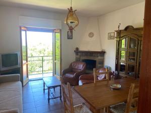 a living room with a table and a fireplace at Pasquina and the Val d'Orcia in Vivo dʼOrcia