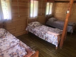a room with three beds in a cabin at Bujtina Diti in Tropojë