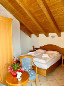 a bedroom with a bed and a table with a chair at Goldenhof in Auer