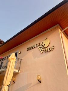 a sign on the side of a building at Goldenhof in Auer +40 photos