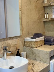 a bathroom with a sink and a mirror at LIV Aspropyrgos in Asprópirgos +28 photos