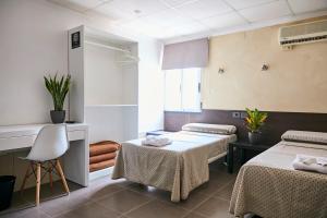 Postel nebo postele na pokoji v ubytování V Pension & Suites
