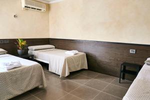 Postel nebo postele na pokoji v ubytování V Pension & Suites
