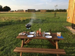 a bird standing on a picnic table in a field at 4 - Cornflower in Woodbridge