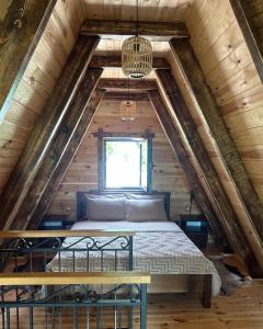 a bed in the attic of a log cabin at Villa Lazar in Žabljak