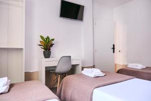 Postel nebo postele na pokoji v ubytování V Pension & Suites