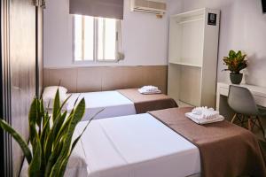 Postel nebo postele na pokoji v ubytování V Pension & Suites