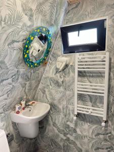 a bathroom with a sink and a mirror on a wall at Magical space Tsikhisdziri in K'obulet'i
