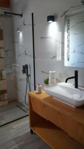 a bathroom with a white sink and a shower at Hotel Natali in Dhërmi +145 photos