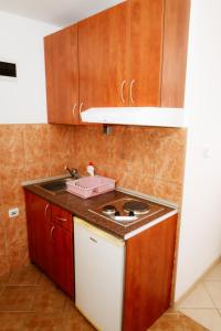 a kitchen with a sink and a counter top at Apartments Ivana in Tivat +177 photos