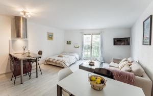 a living room with a couch and a table at Chic appartement, coeur de Saint Tropez, Place des Lices in Saint-Tropez