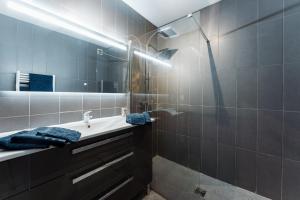 a bathroom with a sink and a shower at Chic appartement, coeur de Saint Tropez, Place des Lices in Saint-Tropez +11 photos