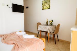a bedroom with a table and a bed and a table and chairs at Apartments Ivana in Tivat