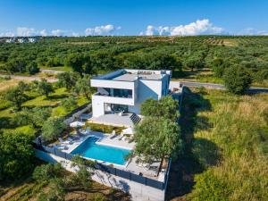 an aerial view of a villa with a swimming pool at Apartment Vista Mare 2 with heated pool in Sveti Filip i Jakov