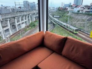 东京枕木 New house with Huge View for Family-Group的一张沙发，坐在一列火车的窗前