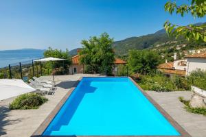 a swimming pool in a villa with a view at Apartman Lea - Villa Oleander in Ičići
