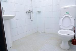 a bathroom with a toilet and a sink at Primland Hotel Buyala in Buloba +25 photos