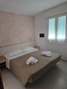 Postel nebo postele na pokoji v ubytování Hotel Gioiella