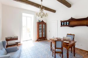 a living room with a table with a laptop on it at Relais Palazzo Cacace in Meta
