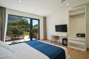 a bedroom with a large bed and a large window at Ella Suites Apartments in Terrasini