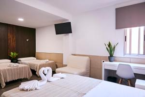 Postel nebo postele na pokoji v ubytování V Pension & Suites