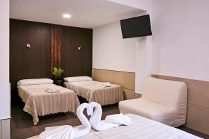 Postel nebo postele na pokoji v ubytování V Pension & Suites