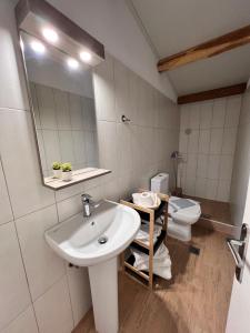 a bathroom with a sink and a toilet at Estia Rooms in Olympiada +27 photos
