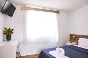 Postel nebo postele na pokoji v ubytování V Pension & Suites