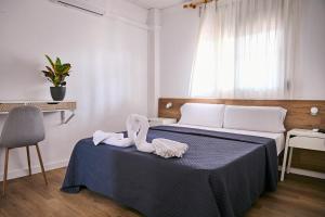 Postel nebo postele na pokoji v ubytování V Pension & Suites