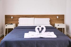 Postel nebo postele na pokoji v ubytování V Pension & Suites