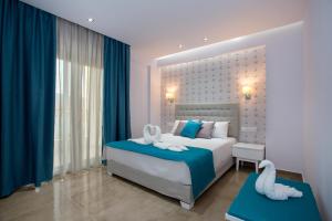 a bedroom with a bed with swans on it at Patiras Deluxe B&B in Limenaria +64 photos