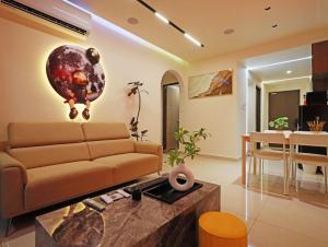a living room with a couch and a dining room at Central Park Premium 4pax unit in Johor Bahru