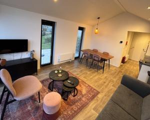 a living room with a couch and a table at Enkhuizer Strand Chalet Meereszauber Nr 304 in Enkhuizen