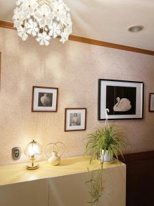 a room with a desk and a chandelier at Citrus Stay in Seoul