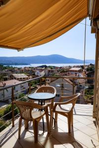 a patio with a table and chairs on a balcony at Apartments Ivana in Tivat