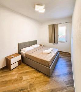 a bedroom with a bed with two towels on it at Villa Priscila - Corte di Pietro in Castelsardo