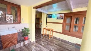 a hallway of a house with a sink and a table at The velox Traditional Home Stay Kalpa in Kalpa