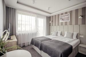 En eller flere senge i et værelse på Dom Gościnny Dana