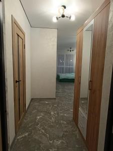 a hallway with two doors and a room with a bed at Апартаменти Ашан Автовокзал Стрийська in Lviv +16 photos