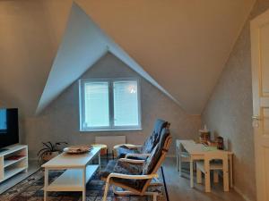a living room with two chairs and a table at Villa Tarvas by Hilla Villas in Rovaniemi