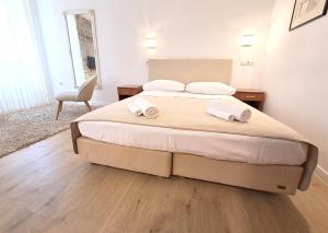 a bedroom with a bed with two towels on it at Medulić Palace Rooms & Apartments 2 in Šibenik +54 photos