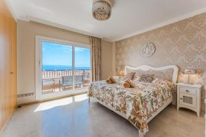a bedroom with a bed and a large window at Spacious Ocean View Family Townhouse in Puerto de Santiago +124 photos