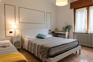 Postel nebo postele na pokoji v ubytování InGarda Rooms