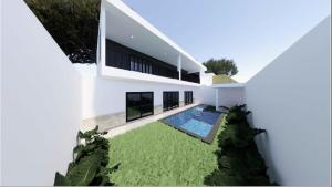 an external view of a white house with a swimming pool at Villa Sensara Sunrise Luxury 3BR in Uluwatu