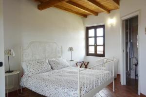 a bedroom with a white bed and a window at Agriturismo Cascina Mora in Pavia