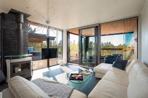 SalmittuにあるStay North - Hirvipolkuの白いソファと暖炉のあるリビングルーム