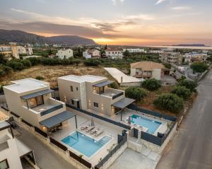 an aerial view of a house with two swimming pools at Petrus Luxury Villas in Old Hersonissos - 3 Bedrooms & 3 Bathrooms in Hersonissos