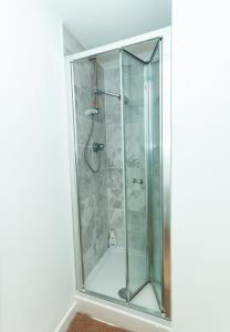 a shower with a glass door in a bathroom at Nay Apartment Two-Bedroom Appt in Coventry in Longford