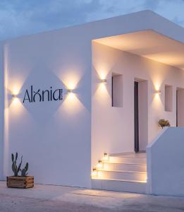 a white building with lights on the side of it at Alonia Suites in Naousa