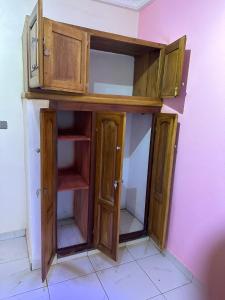 a wooden cabinet in a corner of a room at Tapoko residence in Yaoundé